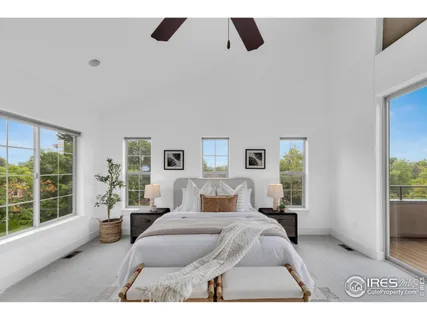 a bedroom with a large bed and a large window