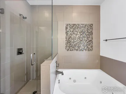 a bathroom with a bathtub and shower