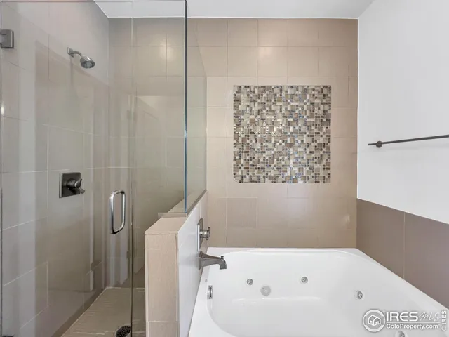 a bathroom with a bathtub and shower
