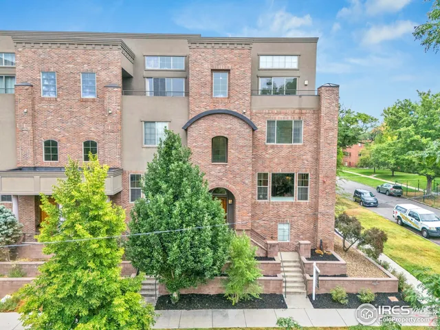 front view of a brick house with a yard