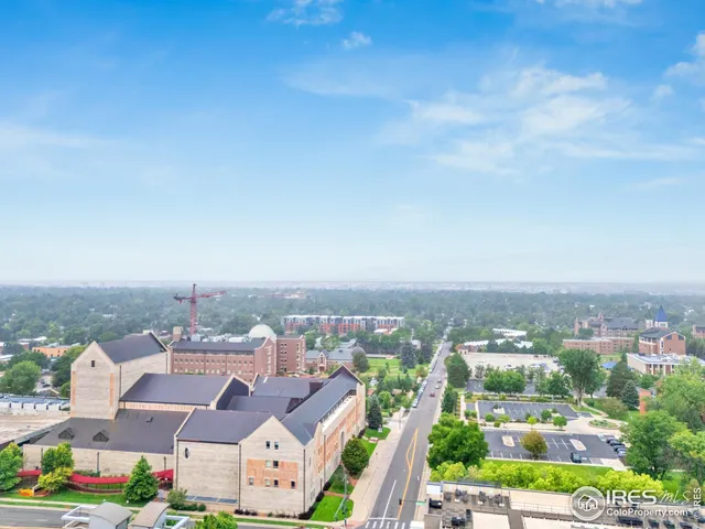 an aerial view of residential houses with city view