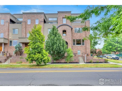 a front view of a house with a garden and plants