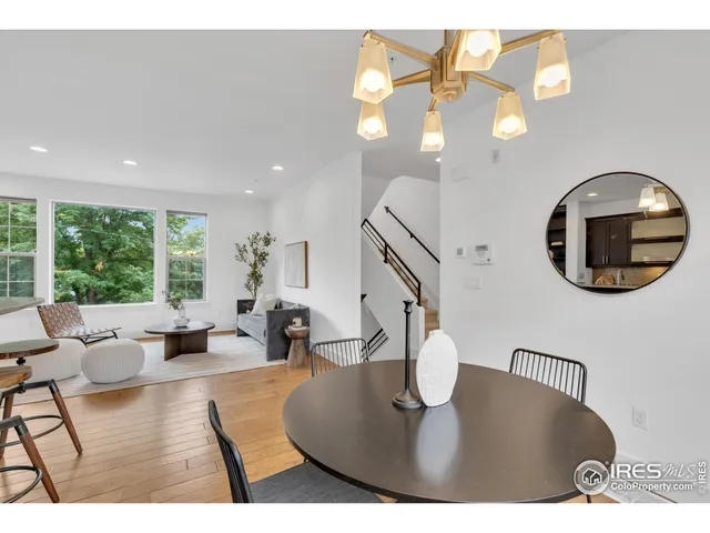 a living room with dining table and a large window with outer view