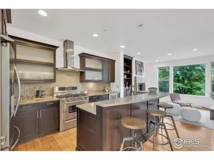 a kitchen with stainless steel appliances a sink stove and cabinets