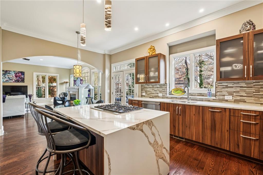 3519 High Grove Way Atlanta, GA 30319 - Photo 11 of 38 a kitchen with stainless steel appliances granite countertop a table chairs sink and wooden floor