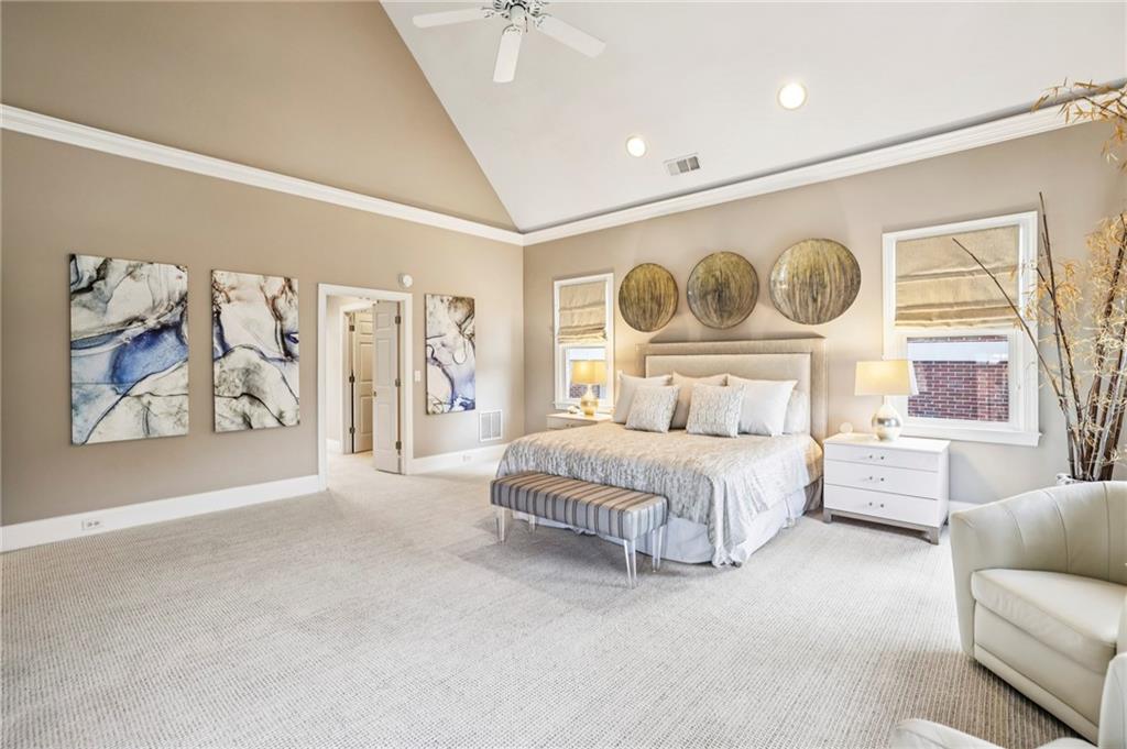 3519 High Grove Way Atlanta, GA 30319 - Photo 18 of 38 a spacious bedroom with a bed and a couch