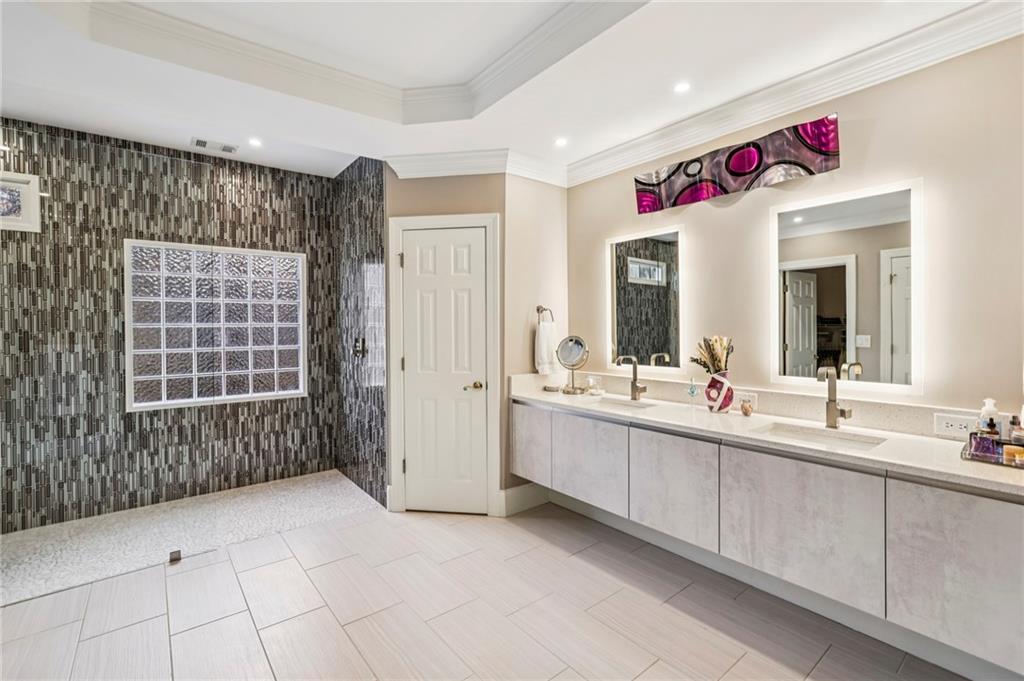 3519 High Grove Way Atlanta, GA 30319 - Photo 19 of 38 a bathroom with a sink mirror and shower