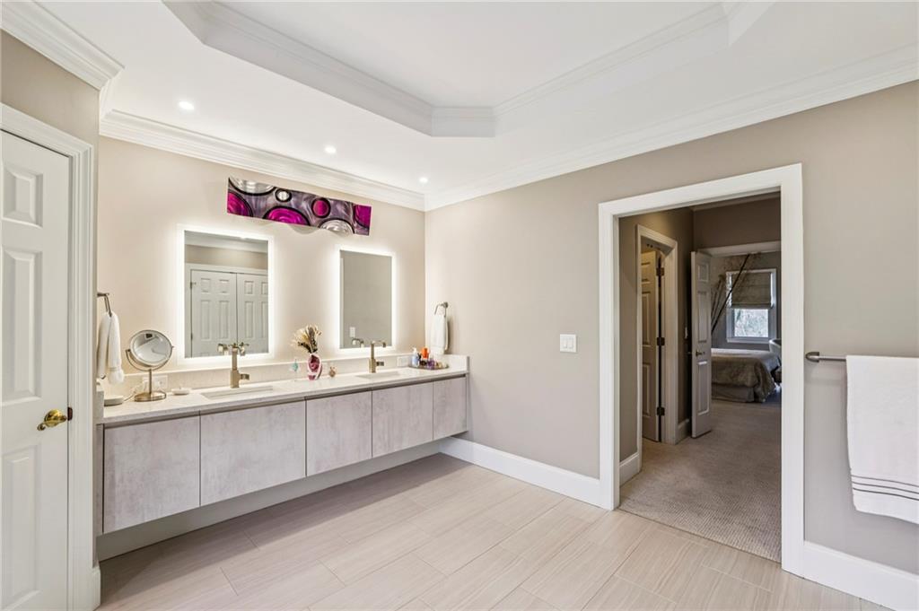 3519 High Grove Way Atlanta, GA 30319 - Photo 21 of 38 a bathroom with double vanity sinks a mirror and a bathtub