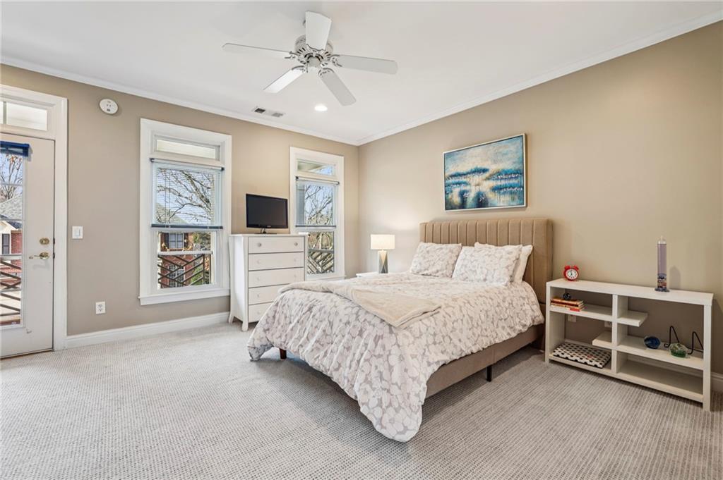 3519 High Grove Way Atlanta, GA 30319 - Photo 23 of 38 a spacious bedroom with a bed a couch and a window