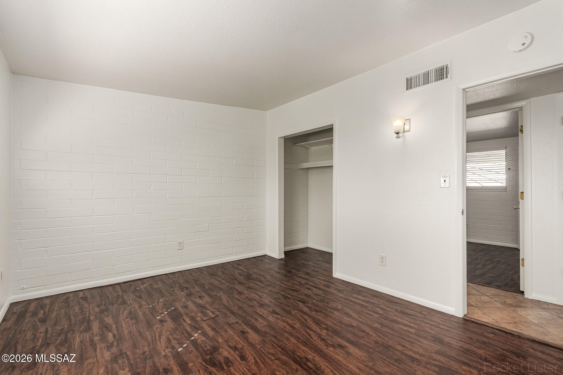 17 East Los Reales Road Tucson, AZ 85756 - Photo 13 of 27 wooden floor in a hall with an empty room