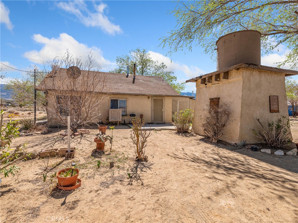 10172 Trade Post Road Lucerne Valley, CA 92356 - Photo 1 of 1 a view of a chairs and tables in the patio