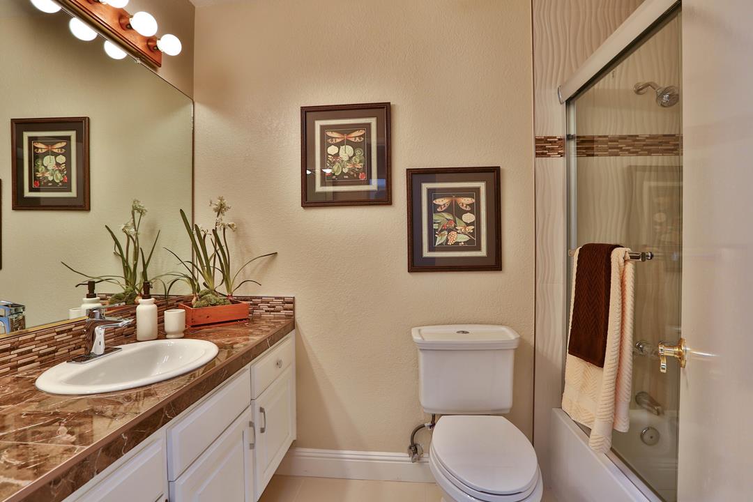6195 Flowering Plum Road San Jose, CA 95120 - Photo 14 of 22 a bathroom with a granite countertop toilet sink and mirror
