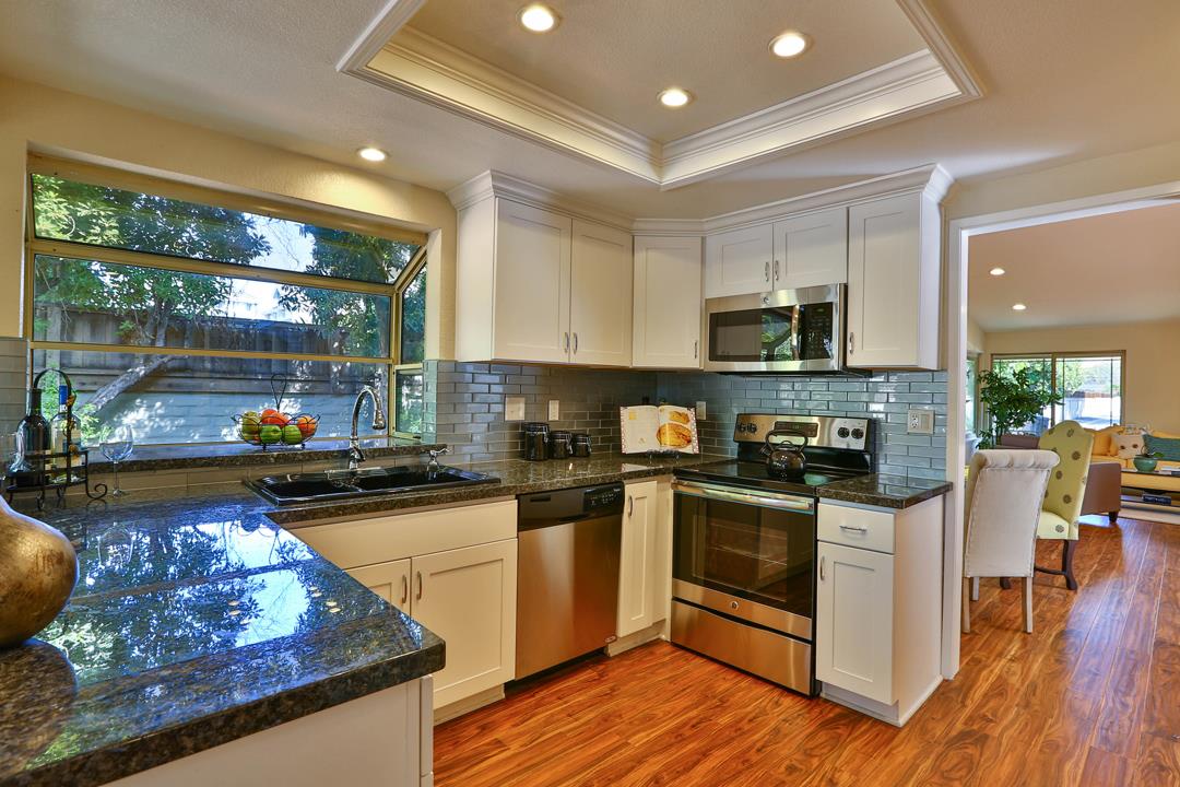 6195 Flowering Plum Road San Jose, CA 95120 - Photo 8 of 22 a kitchen with stainless steel appliances granite countertop a stove a sink and a microwave