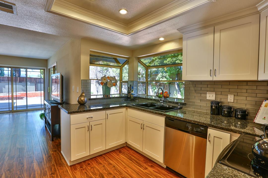 6195 Flowering Plum Road San Jose, CA 95120 - Photo 9 of 22 a kitchen with granite countertop a sink and cabinets