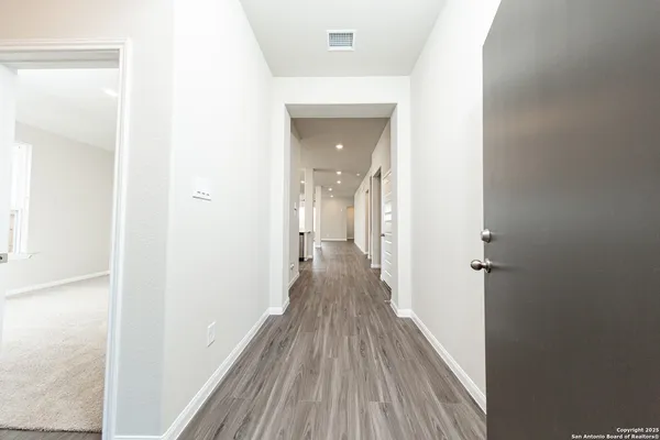 a view of a room with wooden floor