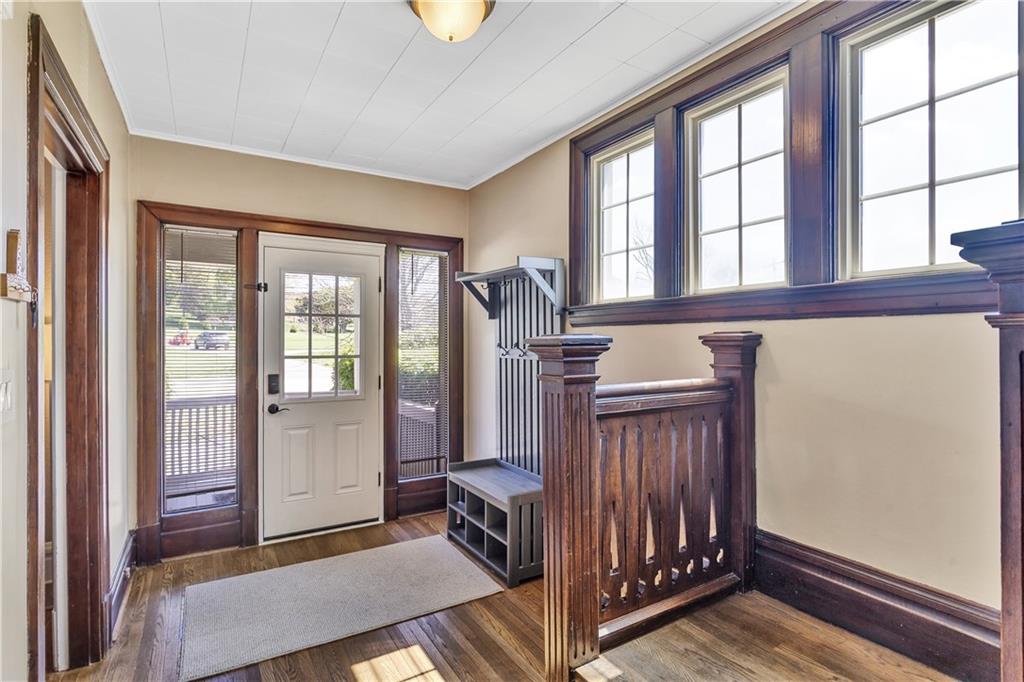 1226 Mayview Road Pittsburgh, PA 15241 - Photo 9 of 42 Natural light highlights the craftsmanship of the wood trim and staircase, creating a bright and inviting first impression.