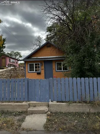 a front view of a house with wooden fence
