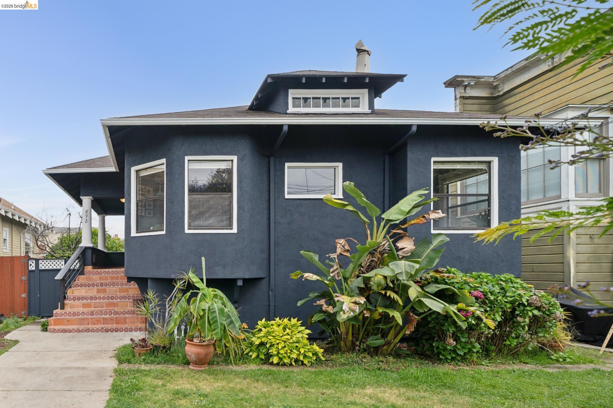 Stucco exterior with contrasting white trim and a prominent bay window