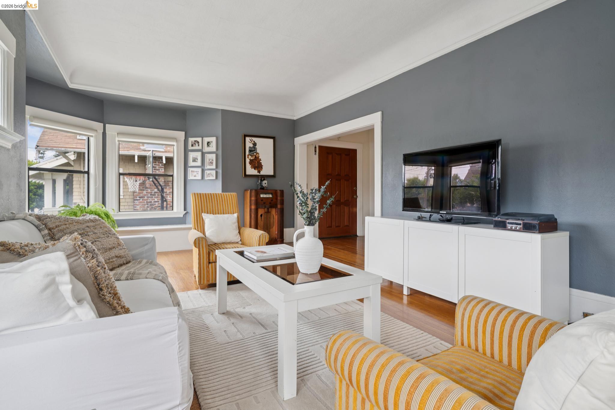 892 Laurel Street Alameda, CA 94501 - Photo 11 of 45 Living area with wood-finish flooring, bay windows, and crown molding
