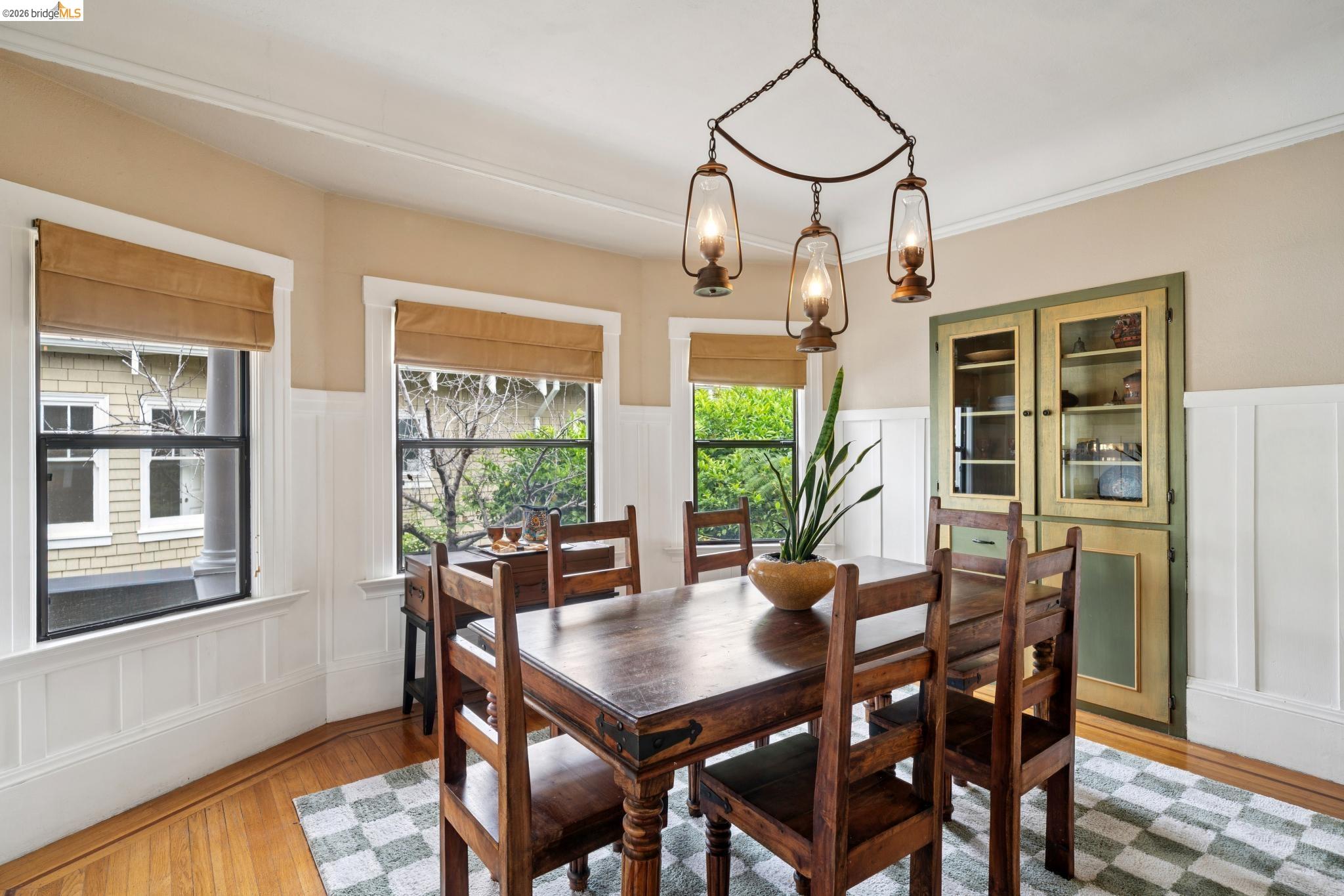 892 Laurel Street Alameda, CA 94501 - Photo 13 of 45 Dining area featuring wainscoting, wood-finish flooring, and a unique lantern-style chandelier