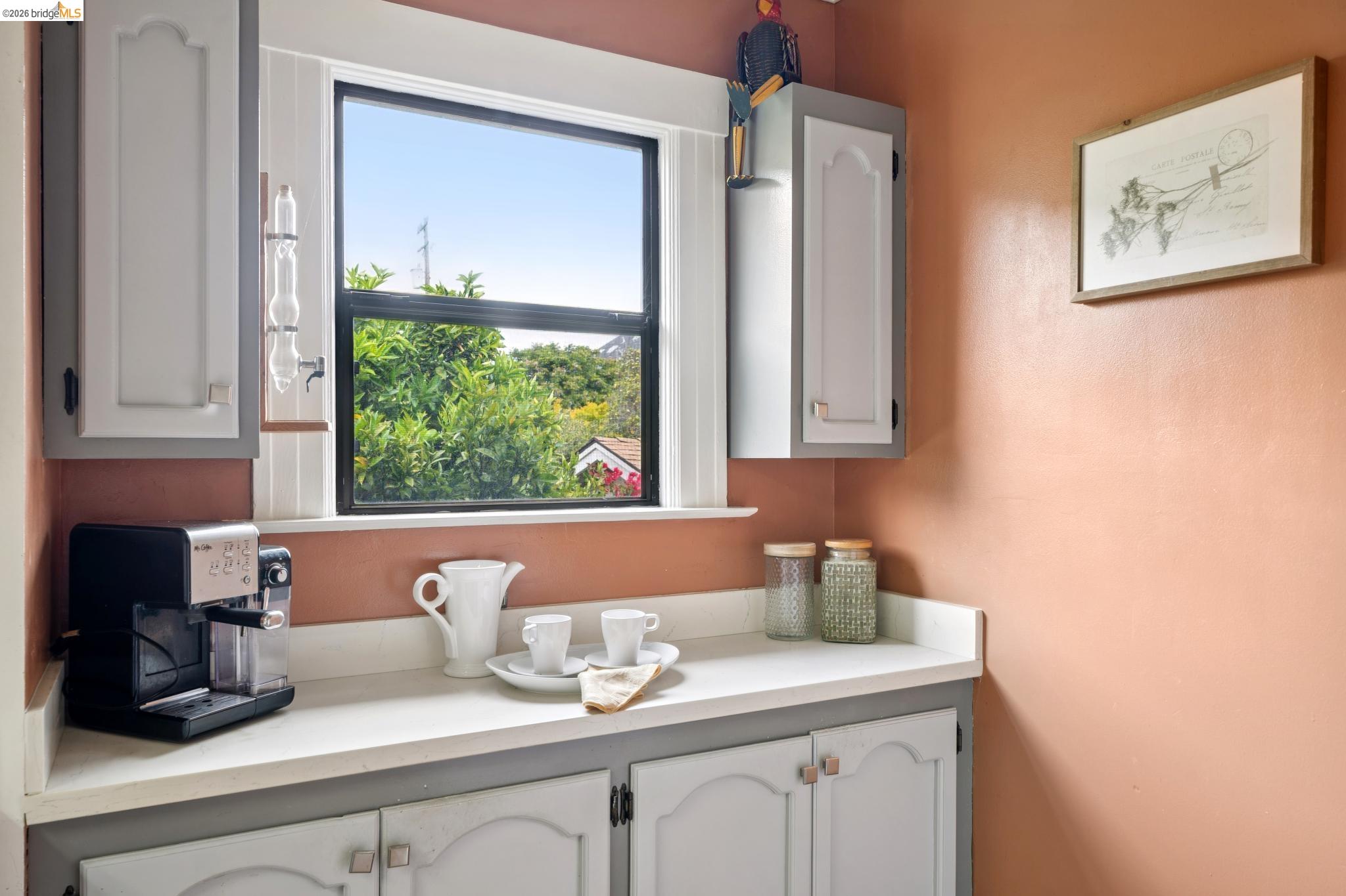 892 Laurel Street Alameda, CA 94501 - Photo 19 of 45 Kitchenette featuring a white countertop, light-toned cabinetry with gray trim, and a black-framed window