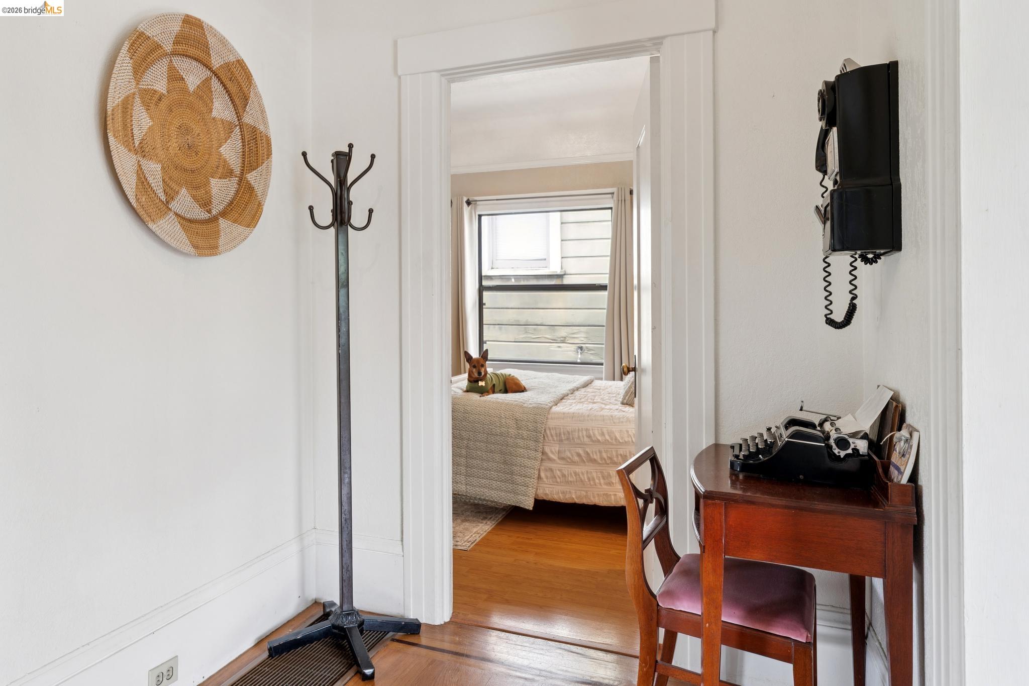 892 Laurel Street Alameda, CA 94501 - Photo 23 of 45 Interior space featuring hardwood flooring, white trim, and a doorway opening to a room with a window