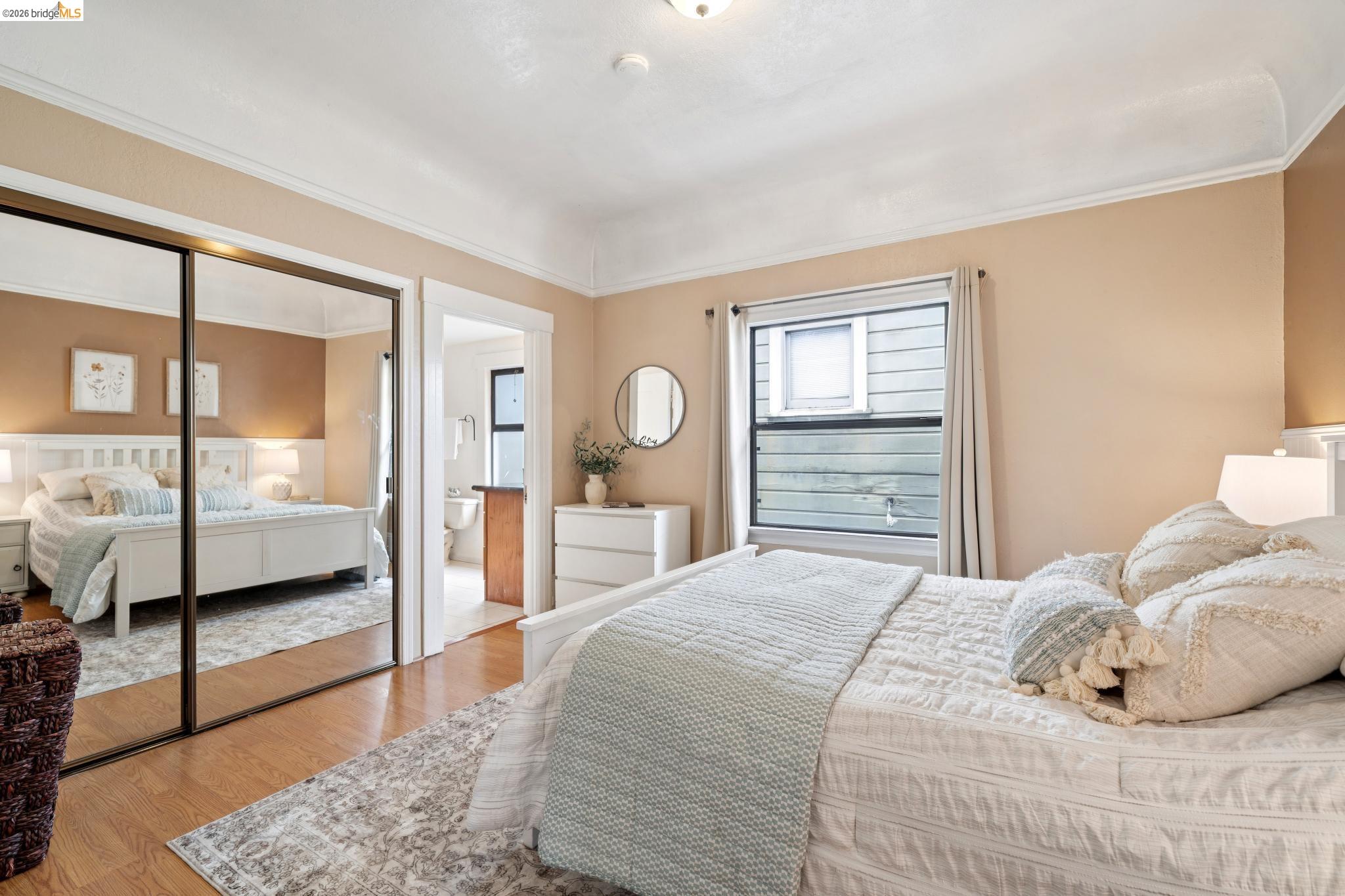 892 Laurel Street Alameda, CA 94501 - Photo 25 of 45 Bedroom with wood-finish flooring, mirrored closet doors, and crown molding