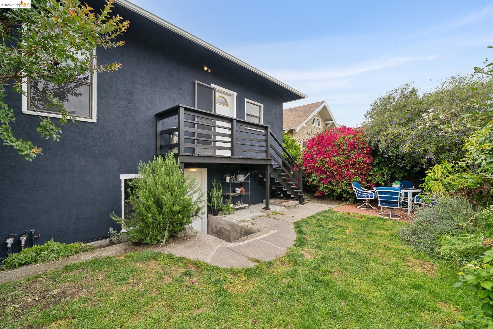 892 Laurel Street Alameda, CA 94501 - Photo 39 of 45 Manicured backyard with a dark-painted exterior and a black-railed deck