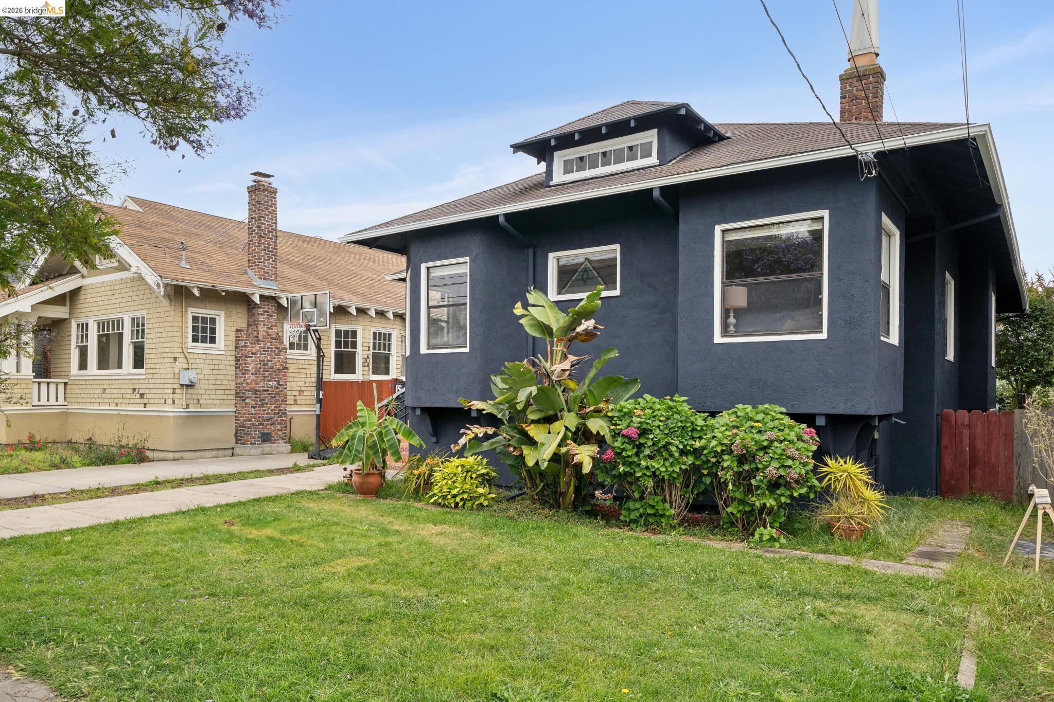 892 Laurel Street Alameda, CA 94501 - Photo 4 of 45 Dark-hued exterior featuring a prominent bay window, white window trim, and a dormer with multiple panes