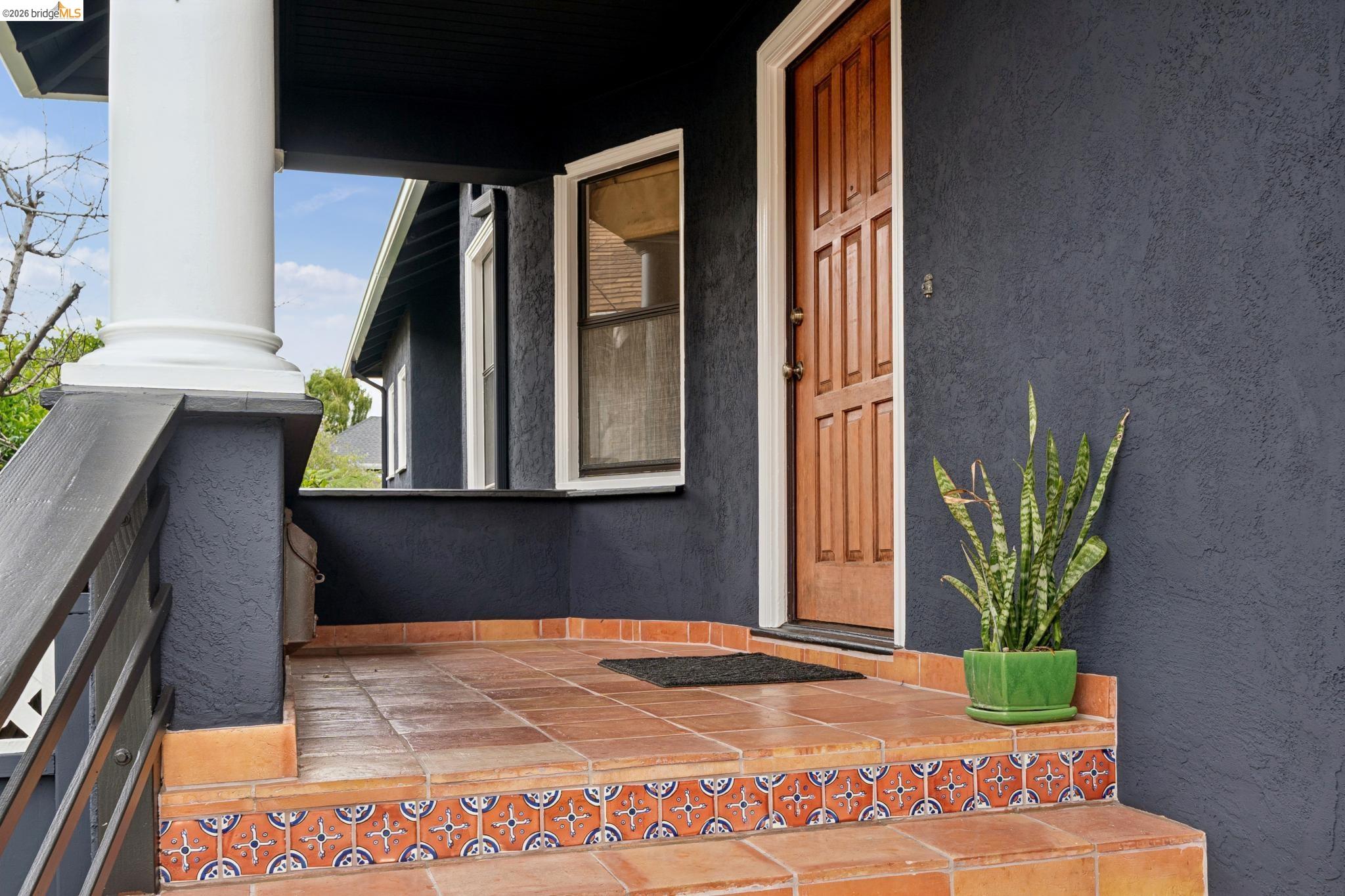892 Laurel Street Alameda, CA 94501 - Photo 5 of 45 Inviting front porch featuring terra cotta-colored tile flooring, decorative tile risers, and a warm wood-paneled entry door