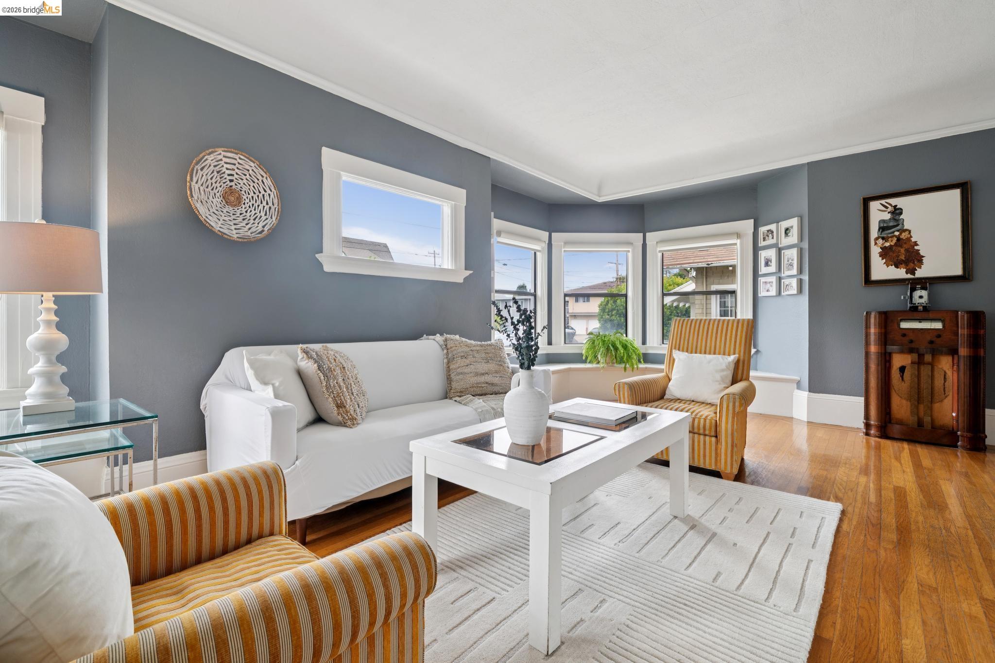 892 Laurel Street Alameda, CA 94501 - Photo 10 of 45 Living area featuring rich wood-finish flooring, light blue walls, and white trim