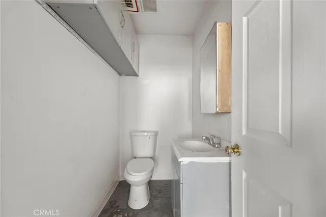 a white toilet sitting next to a bathroom sink