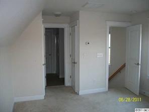 557 Jetton Street Davidson, NC 28036 - Photo 12 of 16 an empty room that has a mirror