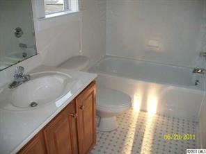 557 Jetton Street Davidson, NC 28036 - Photo 14 of 16 a bathroom with a sink and a large mirror