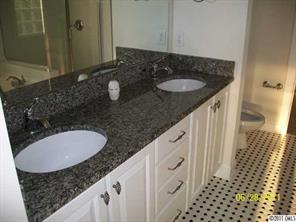 557 Jetton Street Davidson, NC 28036 - Photo 15 of 16 a bathroom with a granite countertop sink and a mirror
