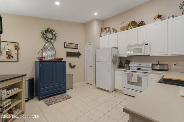 a kitchen with stainless steel appliances a refrigerator sink and cabinets
