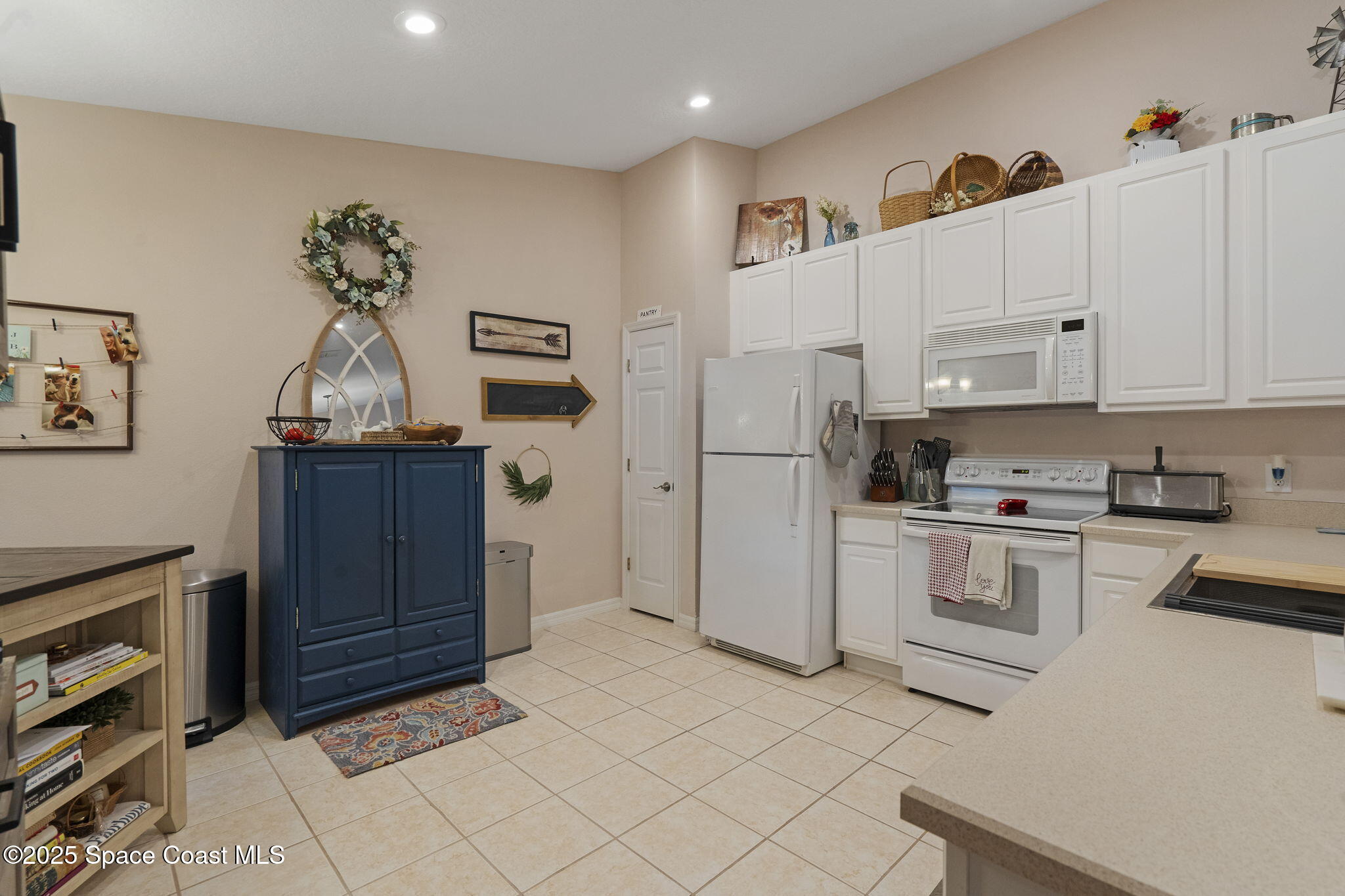 401 Trotter Lane, Unit 202 Melbourne, FL 32940 - Photo 14 of 38 a kitchen with stainless steel appliances a refrigerator sink and cabinets