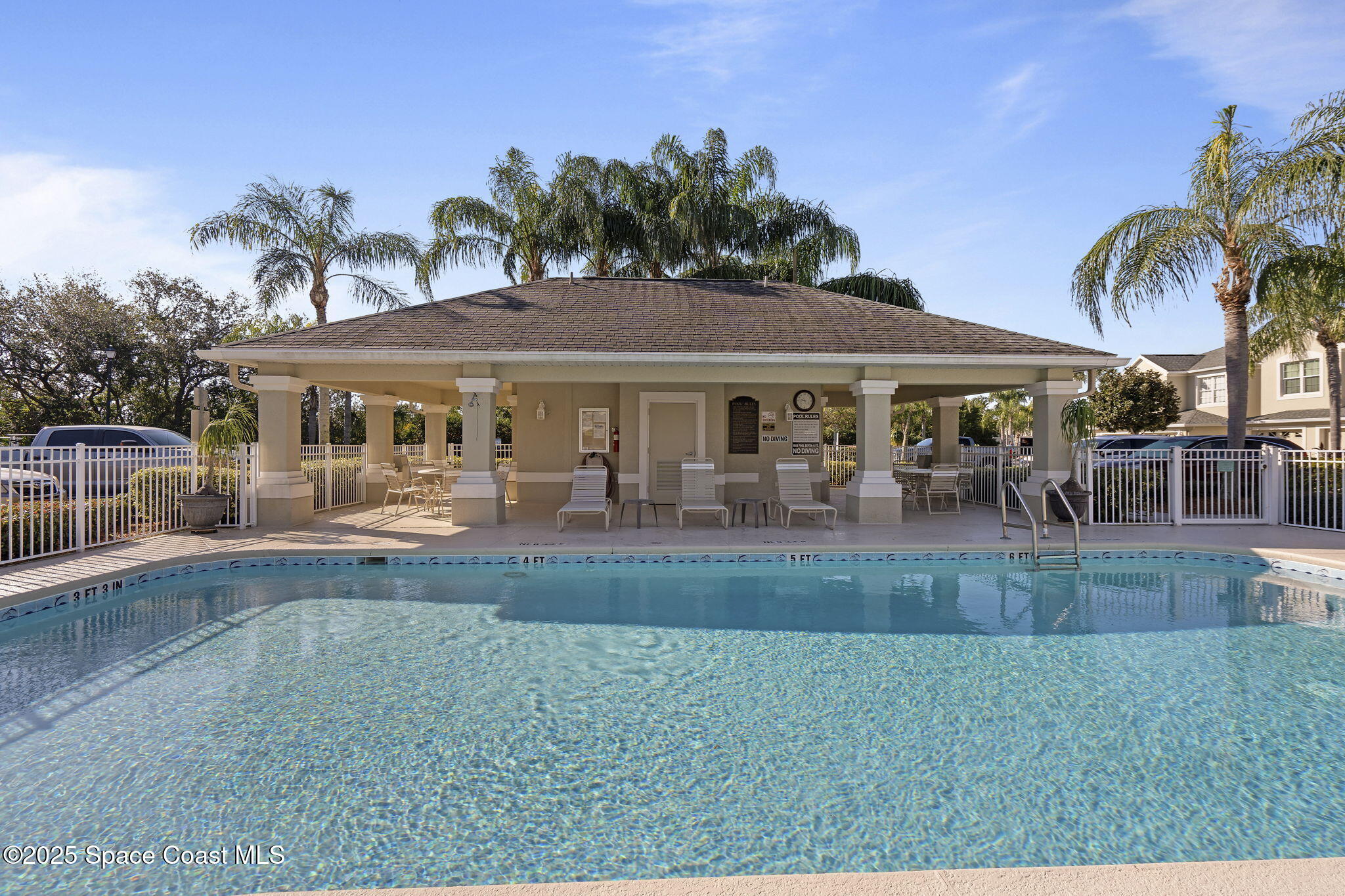 401 Trotter Lane, Unit 202 Melbourne, FL 32940 - Photo 20 of 38 a view of a house with a swimming pool