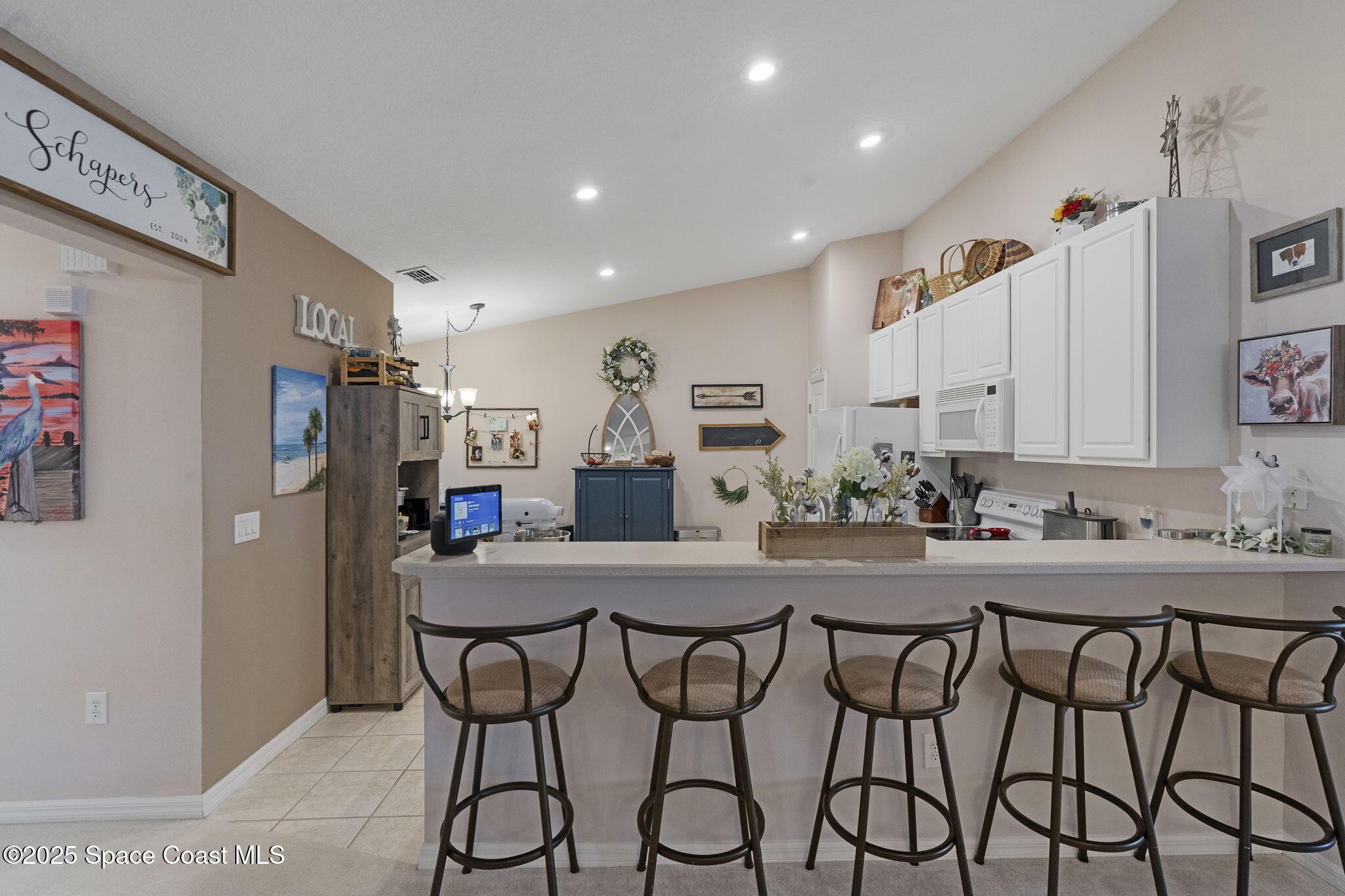 401 Trotter Lane, Unit 202 Melbourne, FL 32940 - Photo 2 of 38 a kitchen with a table and chairs in it