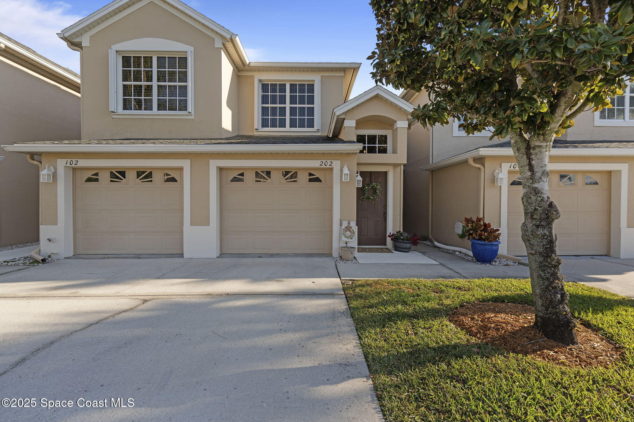 401 Trotter Lane, Unit 202 Melbourne, FL 32940 - Photo 22 of 38 a front view of a house with garden