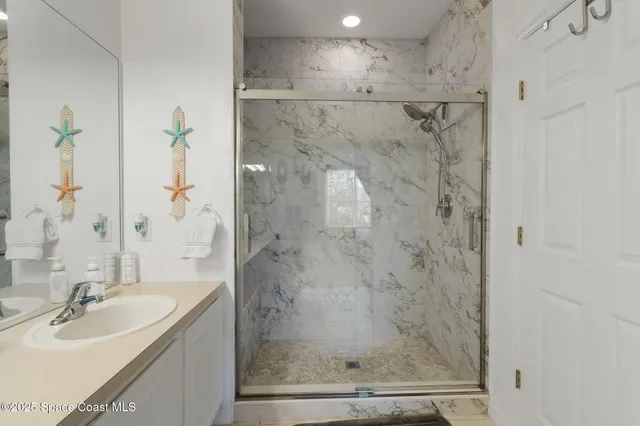 a bathroom with a shower and a sink