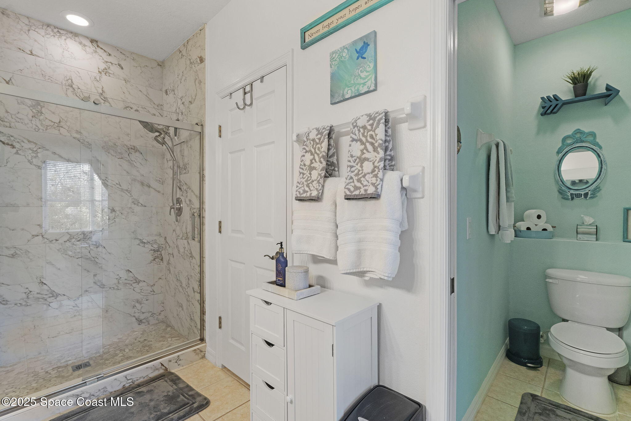 401 Trotter Lane, Unit 202 Melbourne, FL 32940 - Photo 28 of 38 a bathroom with a sink mirror vanity and toilet