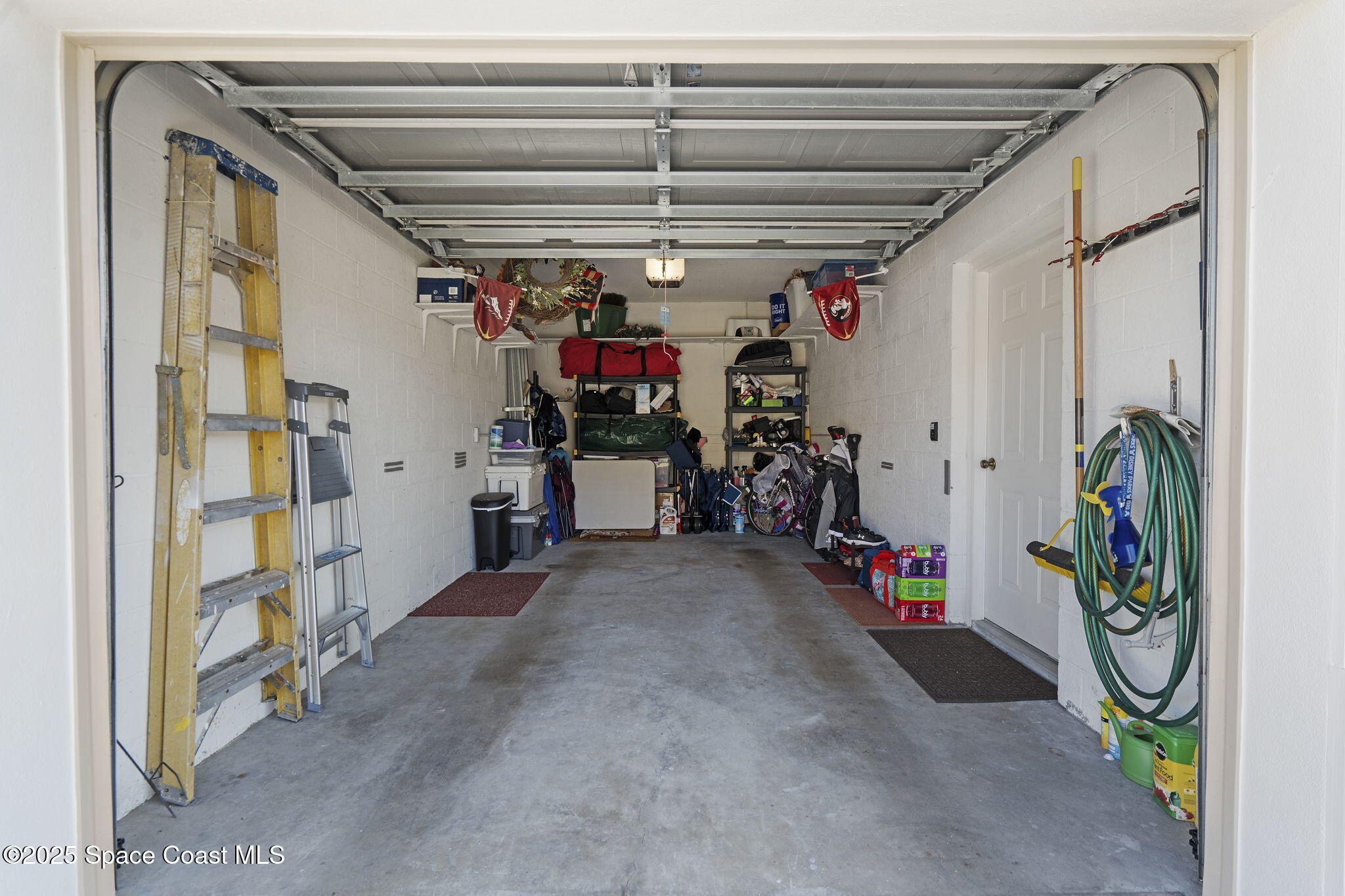 401 Trotter Lane, Unit 202 Melbourne, FL 32940 - Photo 32 of 38 a view of a garage with rack and bicycle