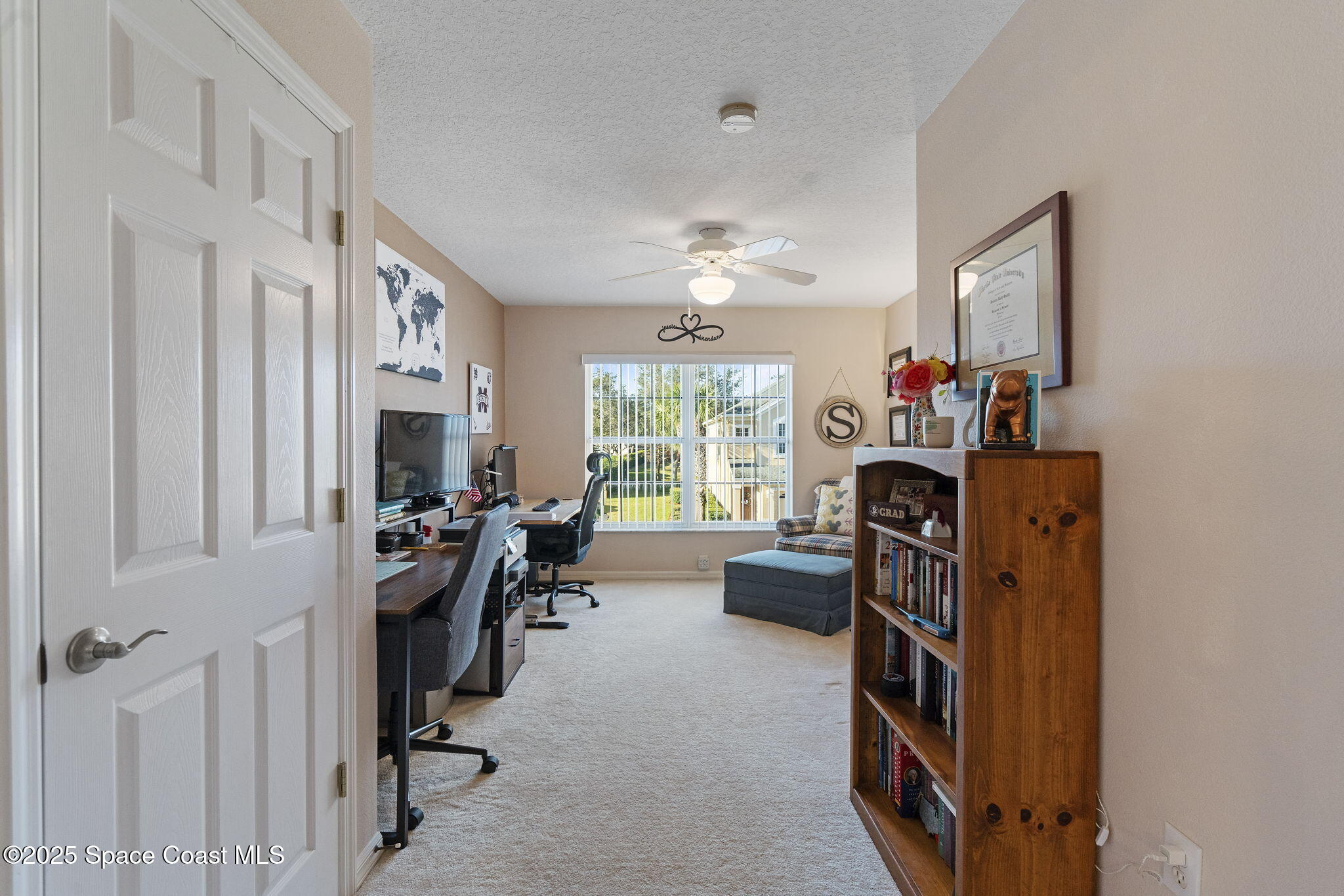 401 Trotter Lane, Unit 202 Melbourne, FL 32940 - Photo 34 of 38 a view of a workspace with furniture and a window