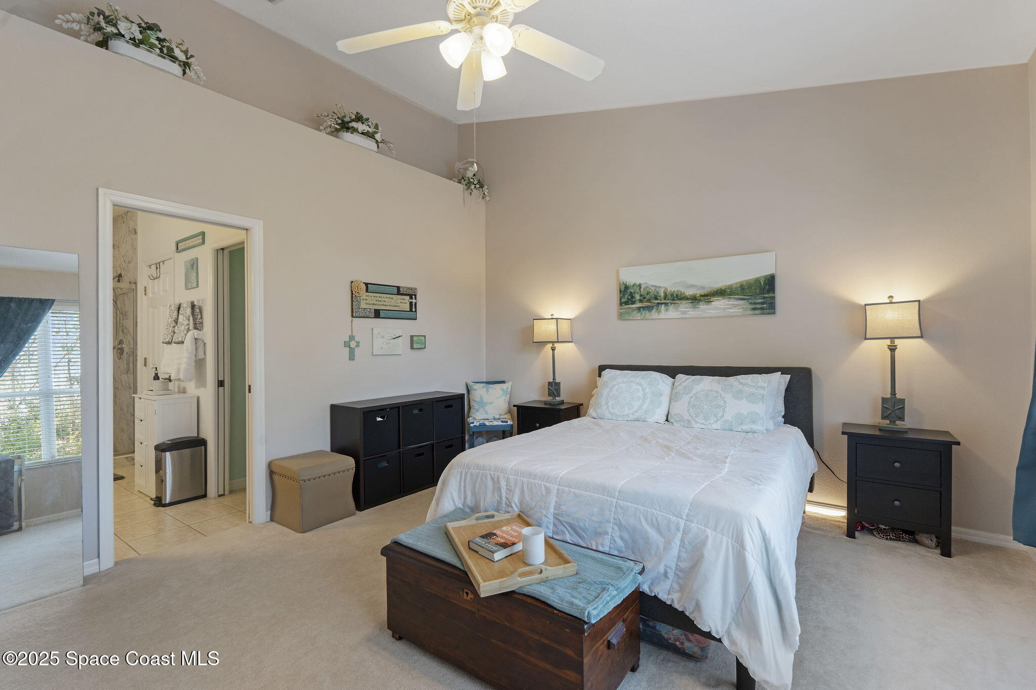 401 Trotter Lane, Unit 202 Melbourne, FL 32940 - Photo 5 of 38 a bedroom with a bed and a chandelier