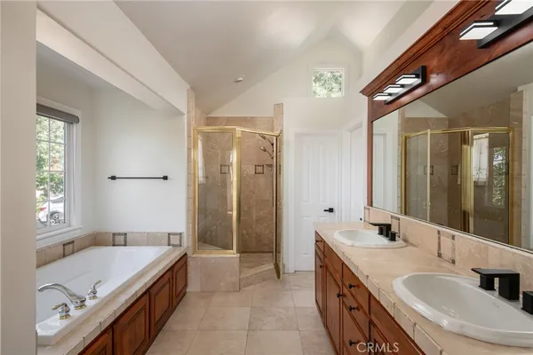 a spacious bathroom with a bathtub shower sink and mirror
