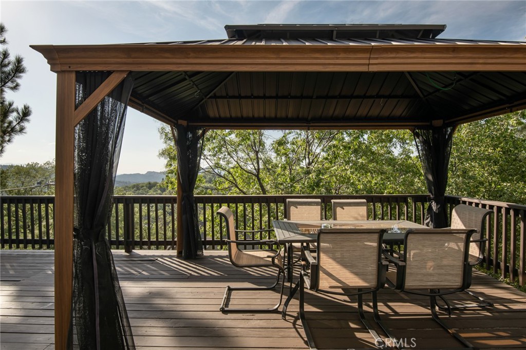 1477 Sequoia Drive Lake Arrowhead, CA 92352 - Photo 19 of 25 a view of a balcony with chairs and wooden floor