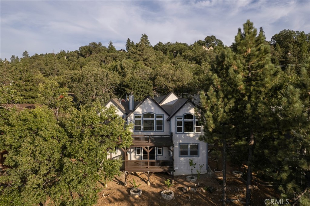 1477 Sequoia Drive Lake Arrowhead, CA 92352 - Photo 23 of 25 a front view of a house with a yard and mountain view in back