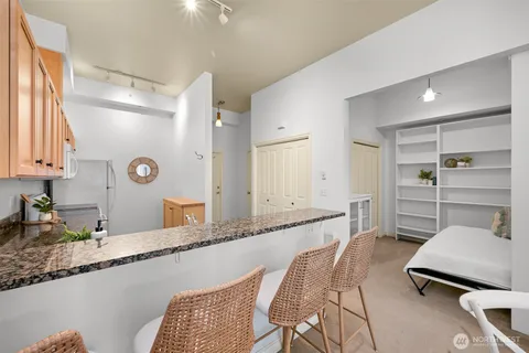 a living room with granite countertop furniture and a wooden floor
