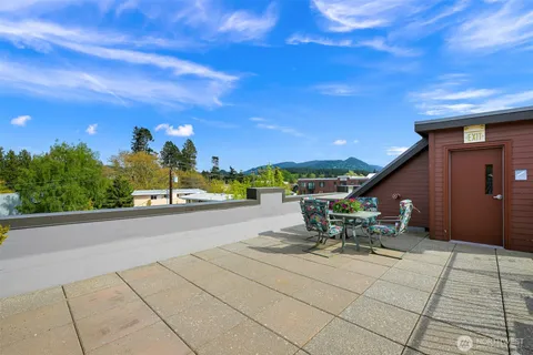 a view of a patio with a table and chairs